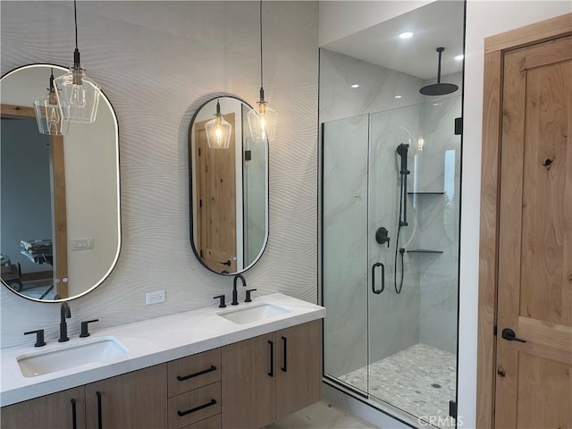 bathroom featuring vanity and a shower with shower door