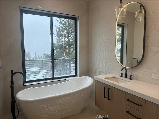 bathroom with vanity and a bathtub