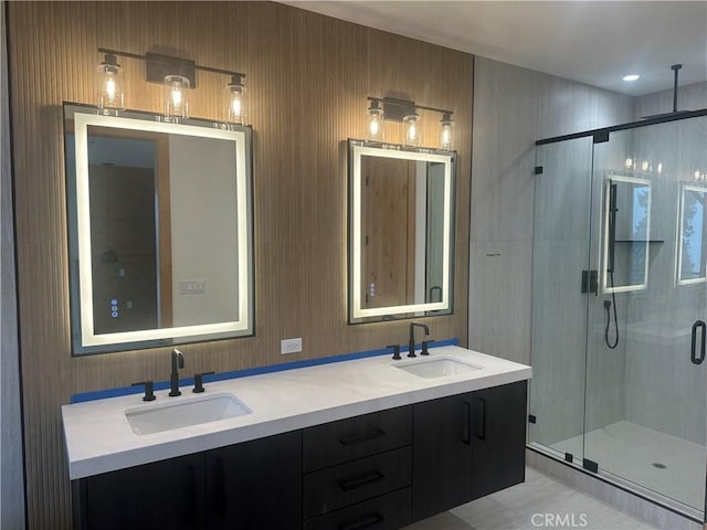 bathroom featuring vanity and a shower with shower door