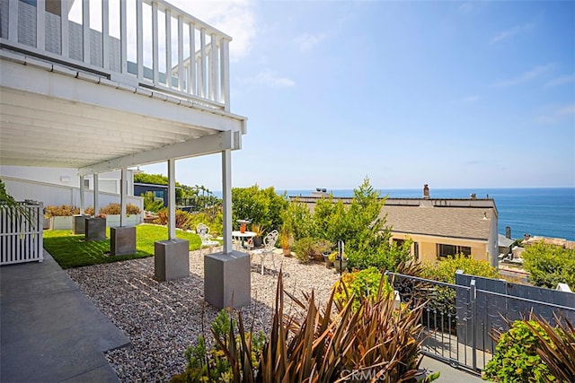 view of patio / terrace with a balcony and a water view