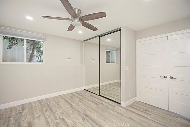 unfurnished bedroom with ceiling fan and light hardwood / wood-style flooring