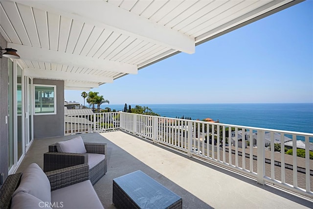 balcony featuring outdoor lounge area, a water view, and ceiling fan