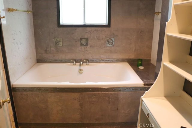 bathroom featuring a relaxing tiled bath