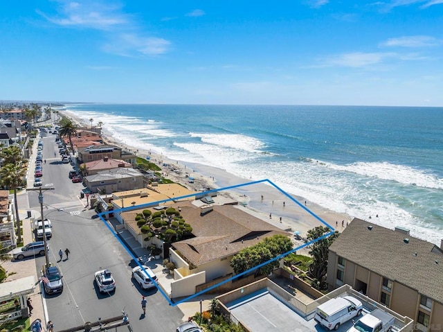 aerial view with a water view and a beach view