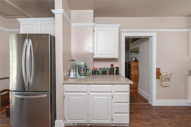 kitchen featuring white cabinets, dark hardwood / wood-style flooring, and stainless steel refrigerator