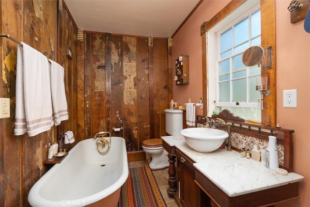 bathroom with a bathing tub, wooden walls, tile patterned flooring, and toilet