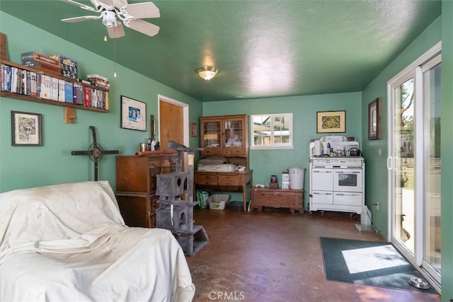 living area featuring a textured ceiling and ceiling fan