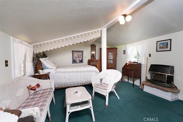 bedroom with a textured ceiling, carpet floors, and vaulted ceiling