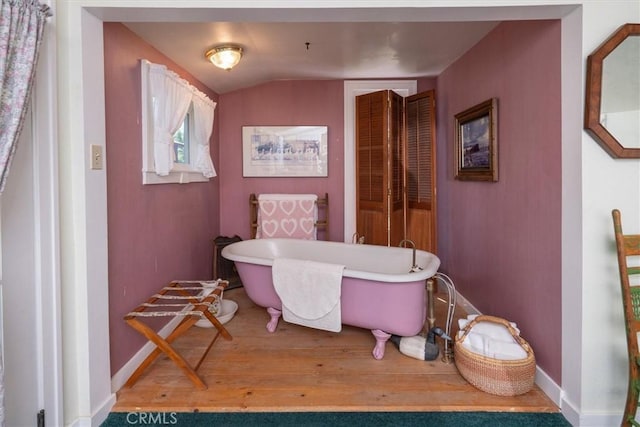 bathroom with a bathing tub and wood-type flooring