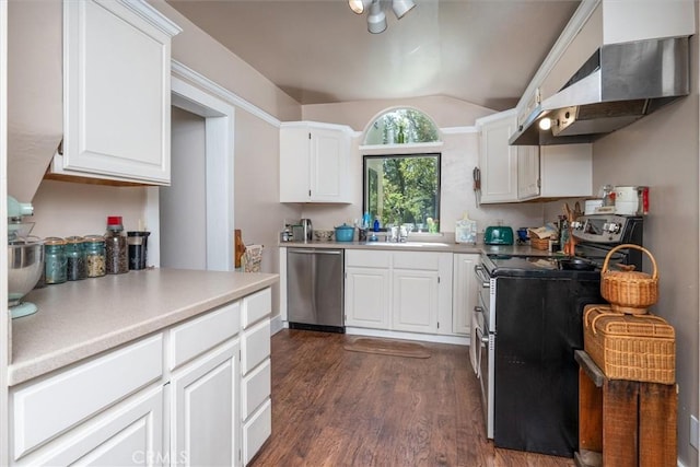 kitchen with dark hardwood / wood-style flooring, lofted ceiling, white cabinets, exhaust hood, and appliances with stainless steel finishes