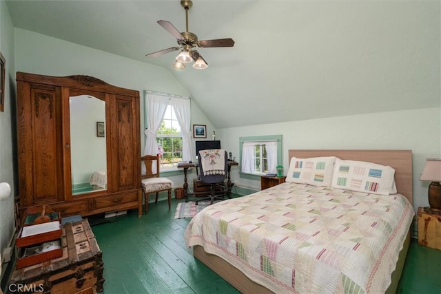 bedroom with vaulted ceiling, ceiling fan, and dark wood-type flooring