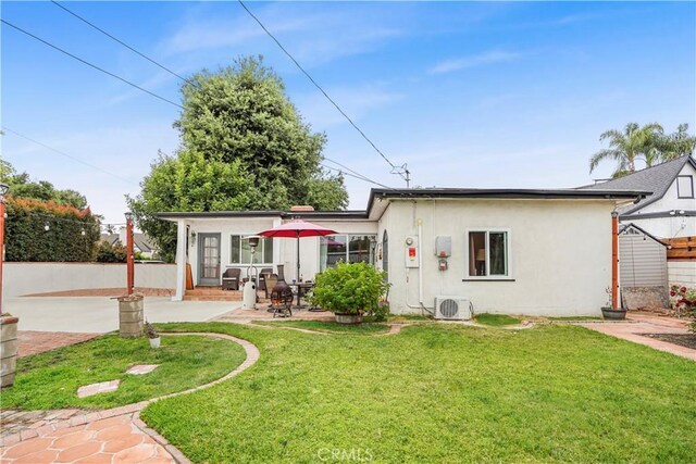 back of house with a patio area, ac unit, and a lawn