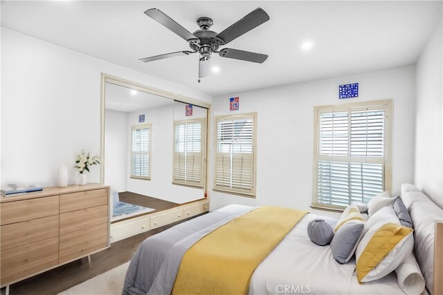 bedroom featuring ceiling fan and dark hardwood / wood-style floors