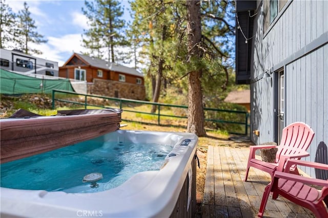 wooden deck featuring a hot tub