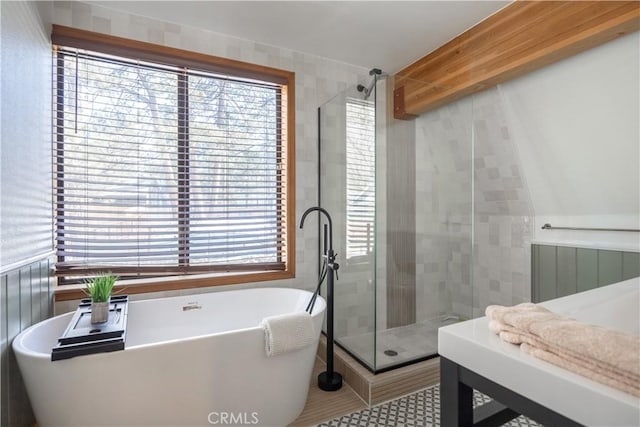 full bathroom featuring radiator, a soaking tub, a shower stall, and tile patterned flooring