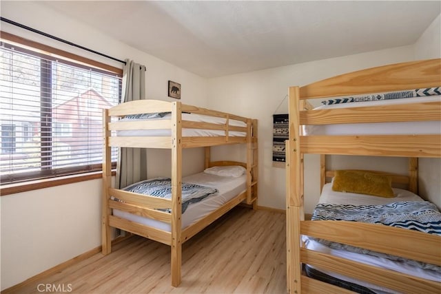 bedroom with light wood-style flooring and baseboards