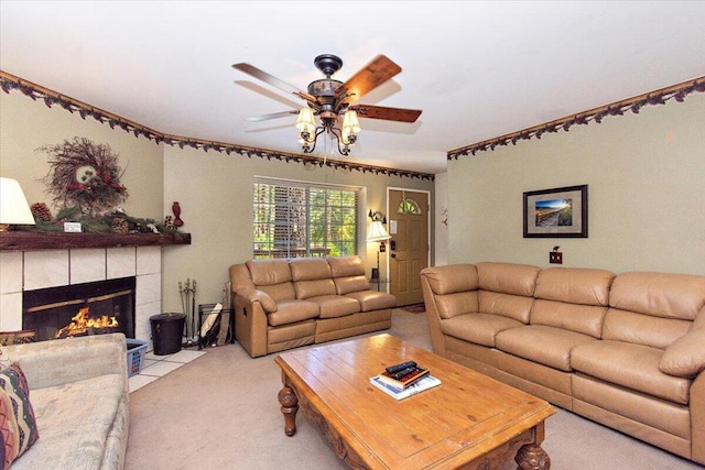 carpeted living room featuring ceiling fan and a tile fireplace