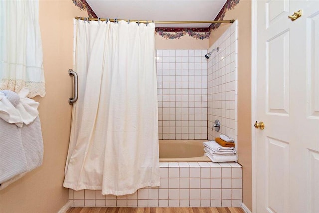 bathroom featuring shower / bath combo with shower curtain and wood-type flooring