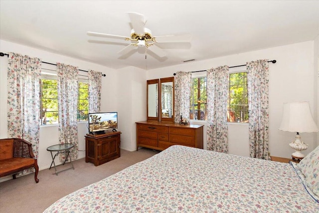 bedroom featuring light colored carpet and ceiling fan