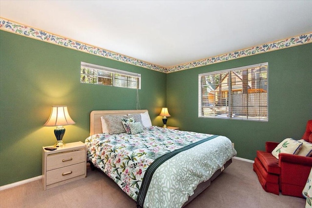 carpeted bedroom with multiple windows