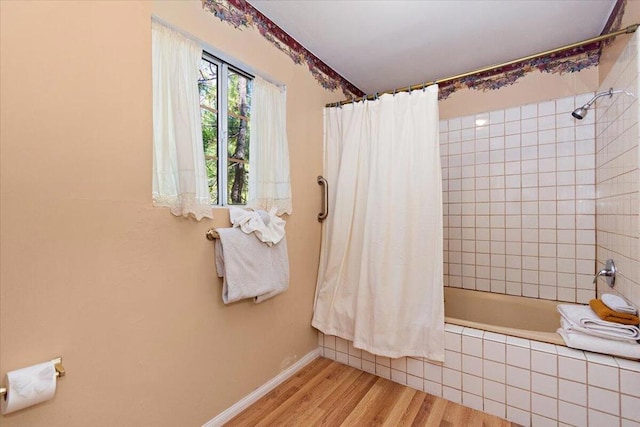 bathroom with shower / bath combo with shower curtain and hardwood / wood-style floors