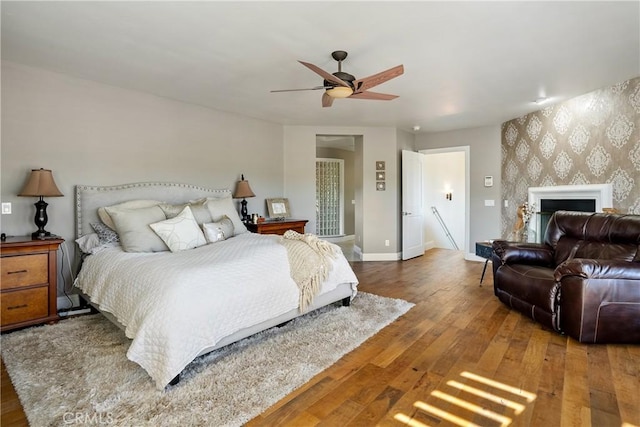 bedroom with ceiling fan and dark hardwood / wood-style floors