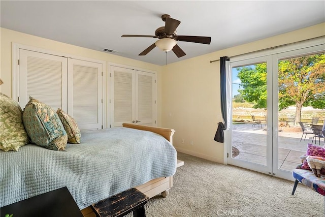 bedroom featuring access to exterior, ceiling fan, light colored carpet, and multiple closets