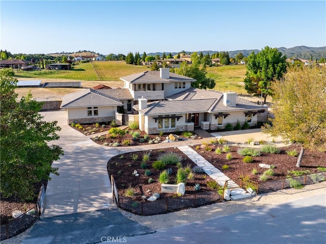 birds eye view of property featuring a mountain view