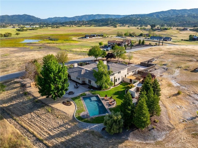 drone / aerial view featuring a mountain view and a rural view