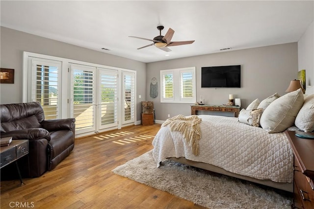 bedroom featuring hardwood / wood-style flooring, ceiling fan, and access to outside