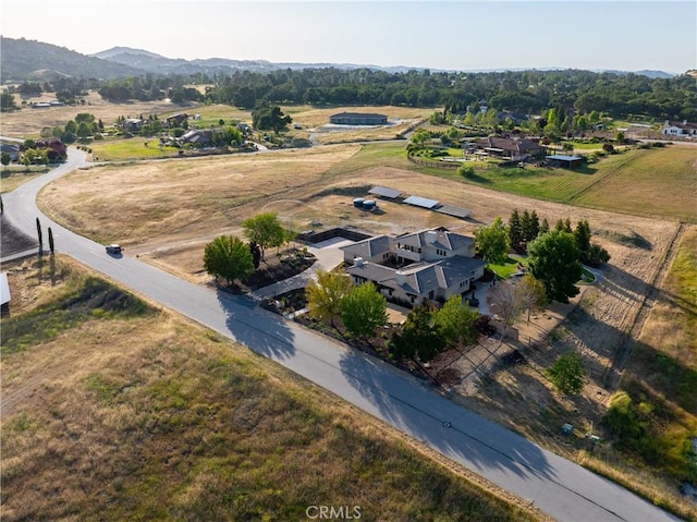 birds eye view of property featuring a mountain view and a rural view