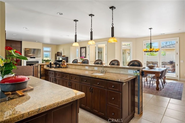 kitchen with pendant lighting, plenty of natural light, and sink