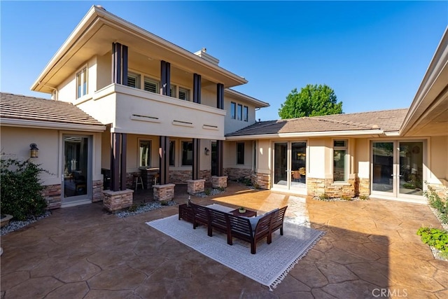 back of house with french doors and a patio