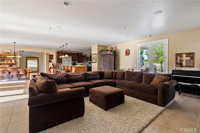 living room featuring light tile patterned floors and a chandelier