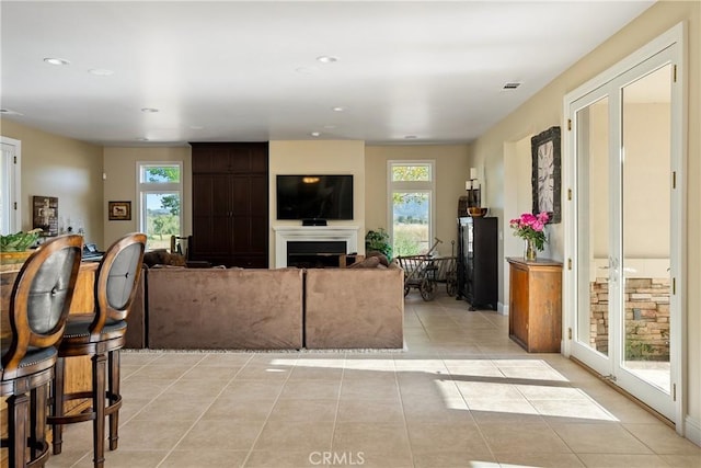 living room with a wealth of natural light and light tile patterned floors