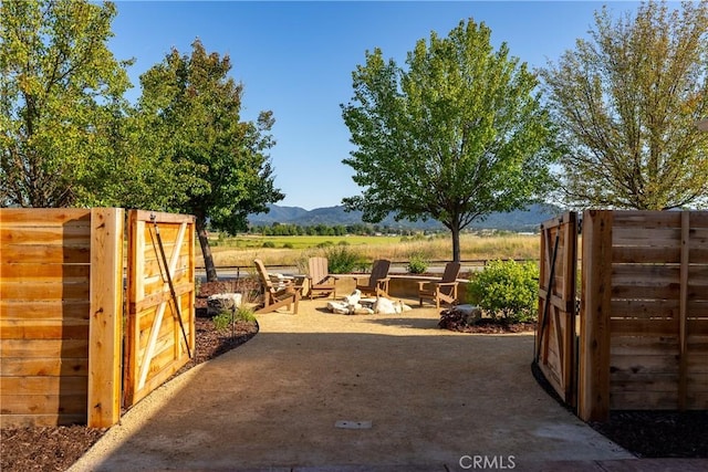 exterior space with a mountain view, a rural view, and a fire pit