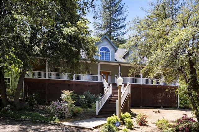 rear view of property featuring covered porch