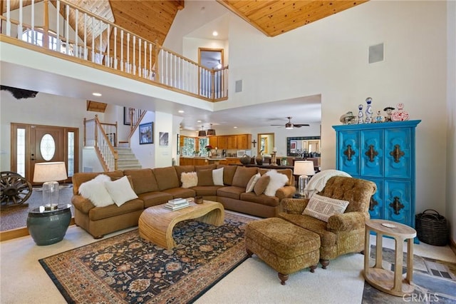 carpeted living room featuring high vaulted ceiling, ceiling fan, and wooden ceiling