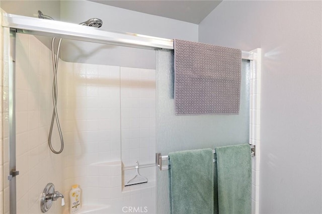 bathroom with a shower with door