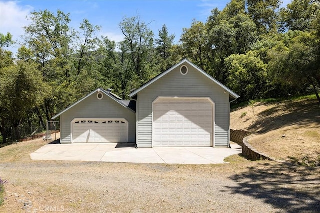 view of front of property featuring a garage and an outbuilding