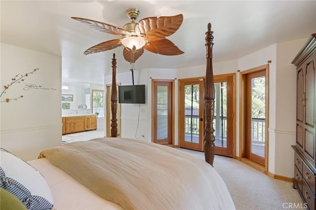 carpeted bedroom with ceiling fan, access to exterior, and ensuite bath