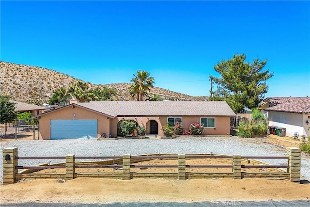 ranch-style house with a mountain view and a garage