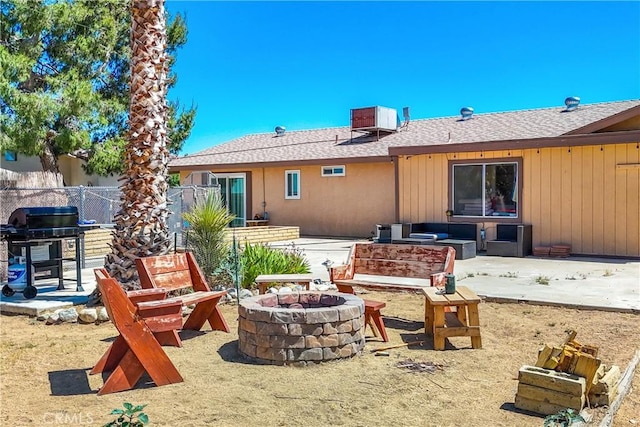 back of house with an outdoor fire pit, a patio, and cooling unit