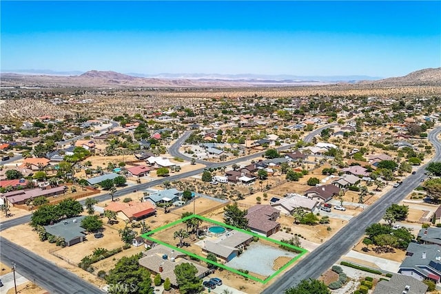 birds eye view of property featuring a mountain view