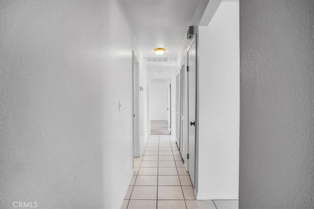 hallway featuring light tile patterned floors