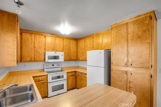 kitchen with white appliances and sink