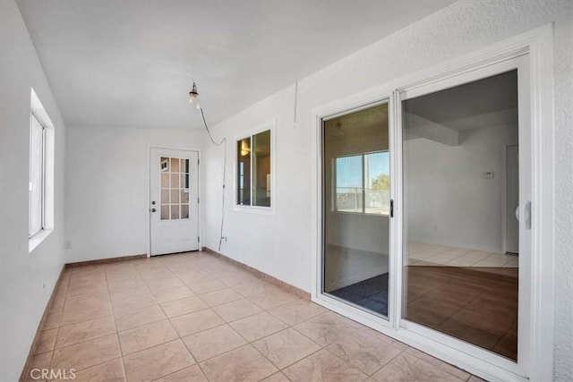 unfurnished sunroom featuring plenty of natural light