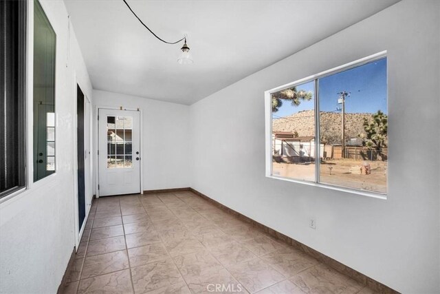 unfurnished room featuring a healthy amount of sunlight