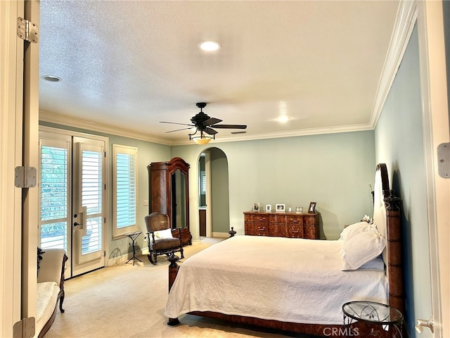 carpeted bedroom featuring ceiling fan, access to exterior, a textured ceiling, and ornamental molding