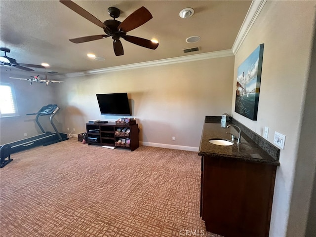 living room with ceiling fan, crown molding, light carpet, and sink